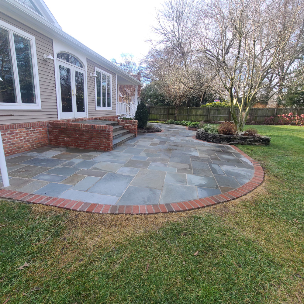stone patio with red brick border