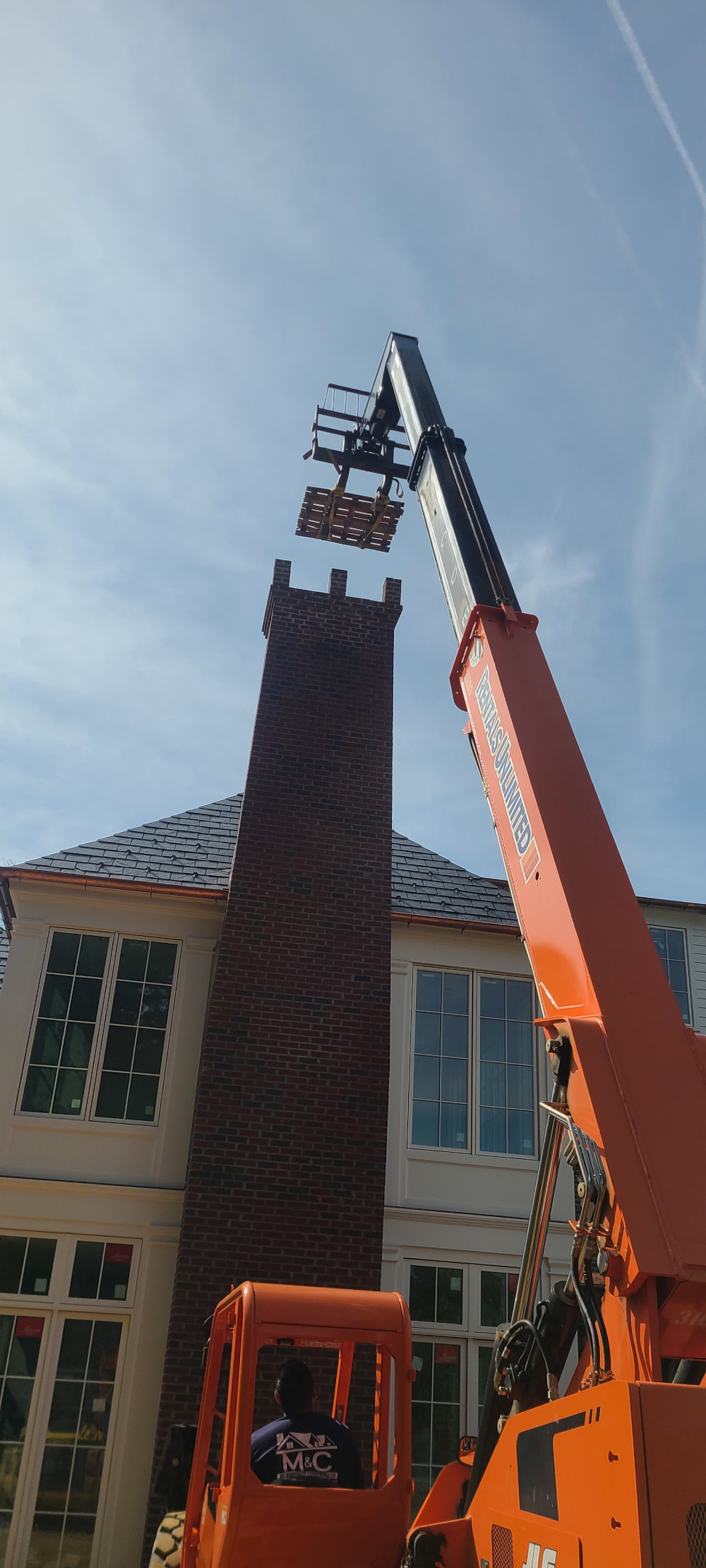Crane lifting material for a chimney
