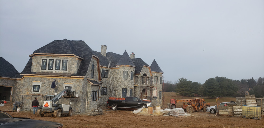 Construction workers building a large house